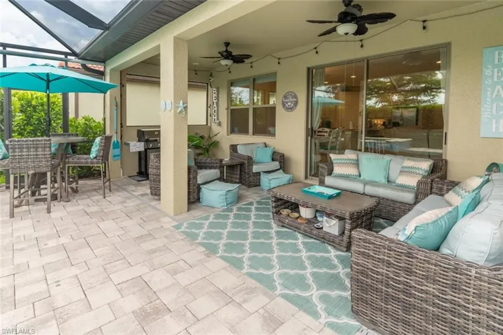 View of patio / terrace with outdoor lounge area, glass enclosure, and ceiling fan