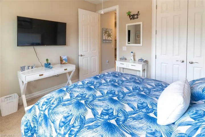 Carpeted bedroom featuring a closet
