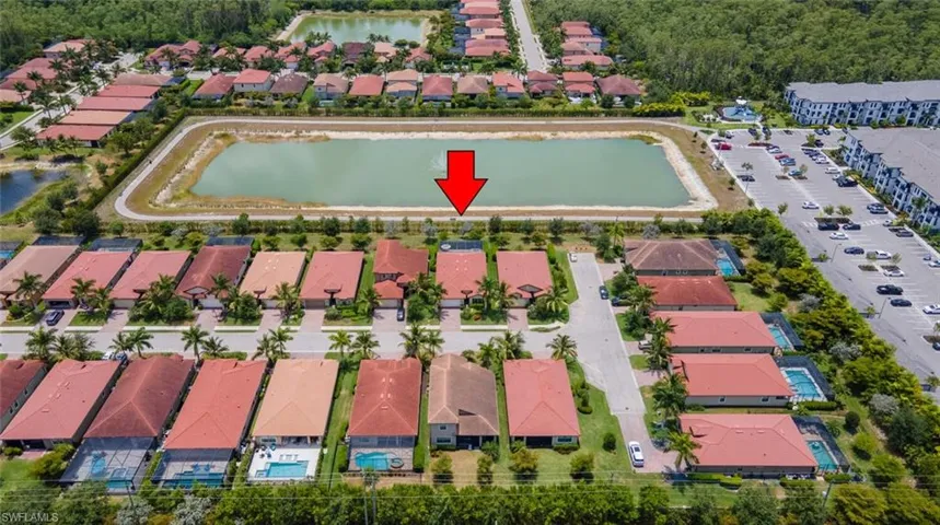 Birds eye view of property with a water view