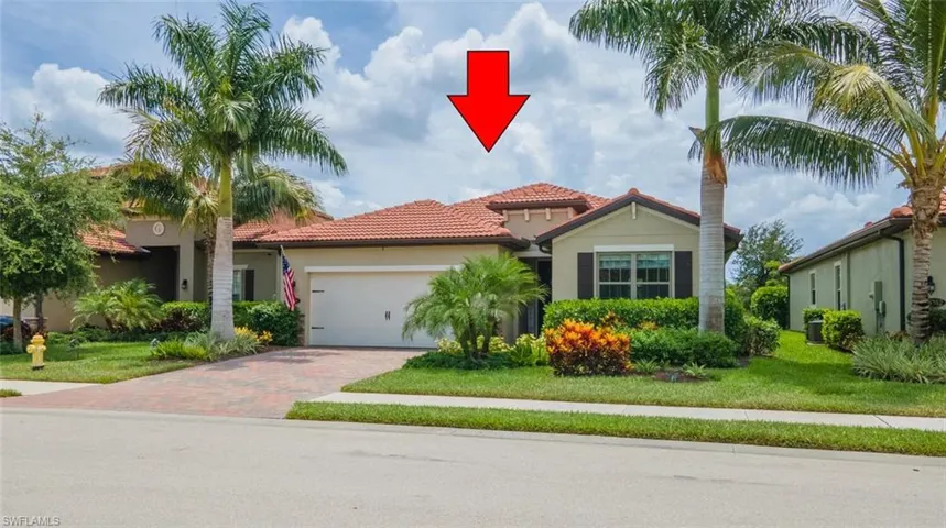 Mediterranean / spanish-style home with a front yard and a garage