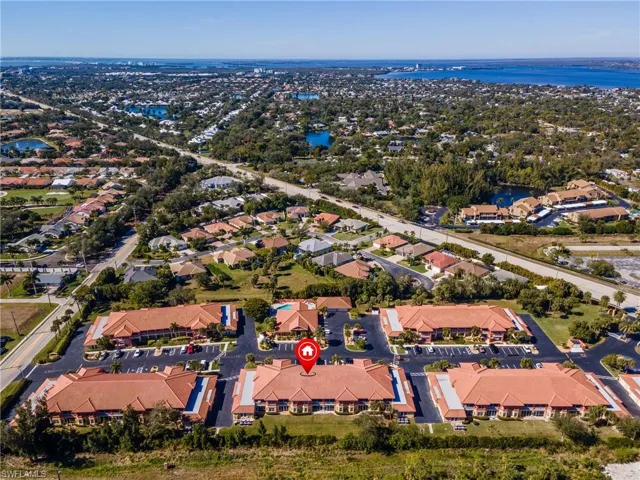 Aerial view of property's location with nearby suburban area