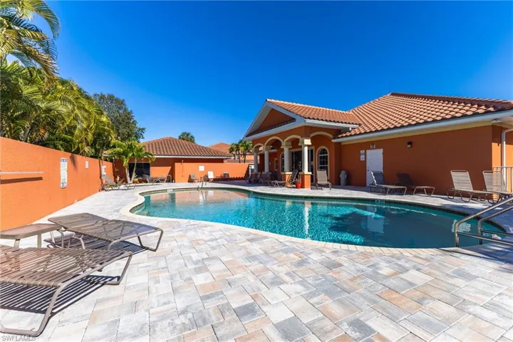 Community pool with a patio