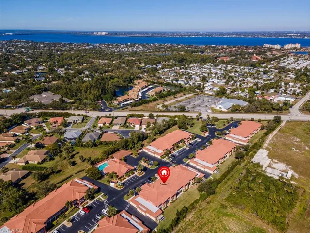 Aerial overview of property's location with nearby suburban area and a large body of water