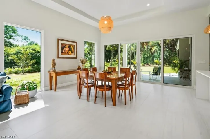 Dining room with plenty of natural light and a raised ceiling