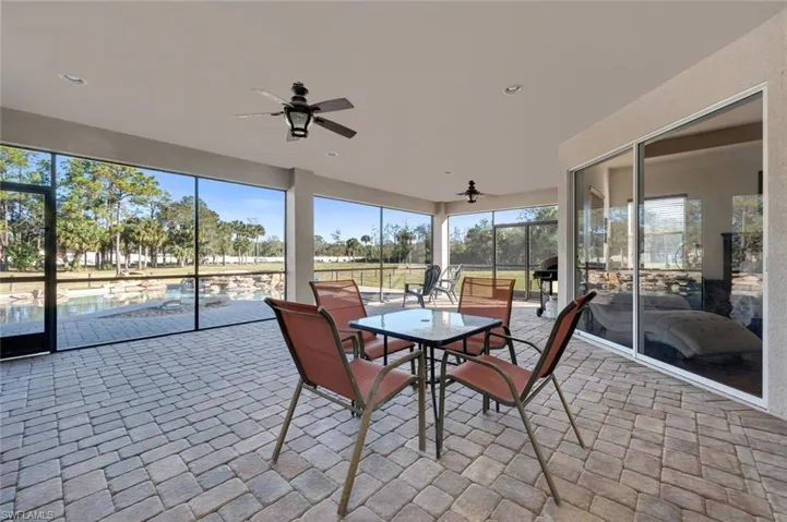 Unfurnished sunroom featuring ceiling fan