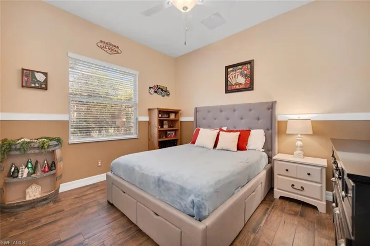 Bedroom featuring dark hardwood / wood-style flooring and ceiling fan