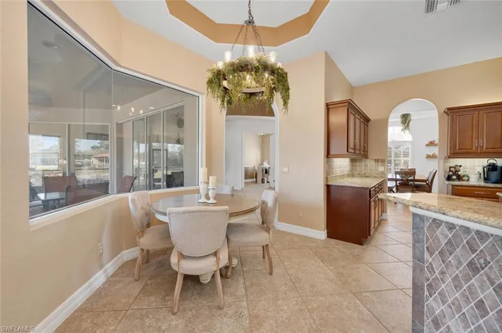Dining area with light tile patterned flooring