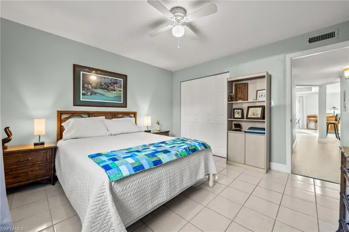 Bedroom featuring a closet, ceiling fan, and light tile patterned flooring