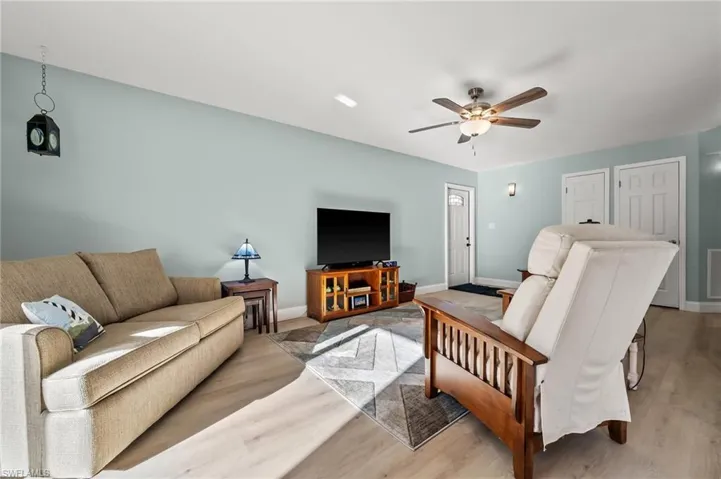 Living room featuring light hardwood / wood-style flooring and ceiling fan
