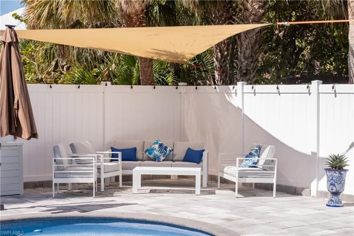 View of swimming pool with an outdoor hangout area, a patio, fence, and a fenced in pool