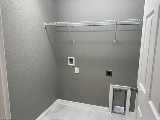 Laundry area featuring a textured wall, washer hookup, and electric dryer hookup