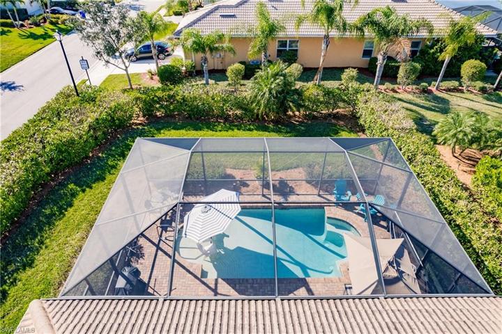 GREAT VIEW OF THE PRIVACY THAT THE PROFESSIONALLY INSTALLED LANDSCAPING PROVIDES!  NOTE HOW LARGE THE POOL CAGE AREA TRULY IS!