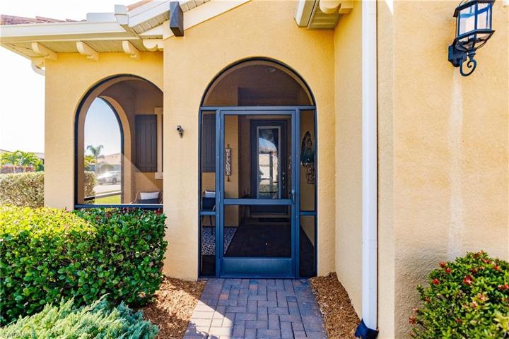 PAVERED DRIVEWAY & ENTRYWAY LEADING TO YOUR COVERED & SCREENED-IN FOYER!