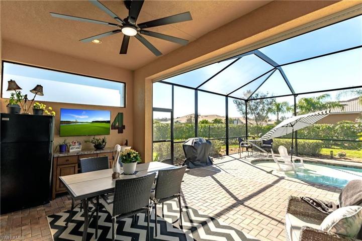 PAVERED POOL LANAI WITH THE "BEACH WALK-IN" AREA WHERE THE ADIRONDACK CHAIRS REMAIN FOR YOUR SUN TAN SESSIONS! THE POOL UMBRELLA & BBQ GRILL ALSO REMAIN WITH THE HOME! TIME TO ENJOY LIFE!