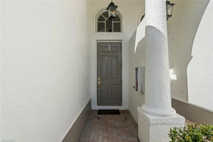 Doorway to property featuring stucco siding