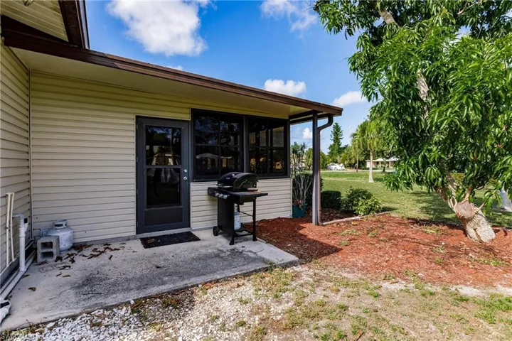 Doorway to property with a lawn