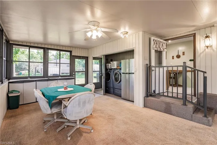 Playroom with light carpet, separate washer and dryer, and ceiling fan