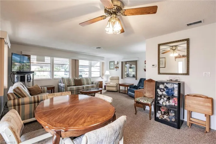 Dining space with carpet floors and ceiling fan