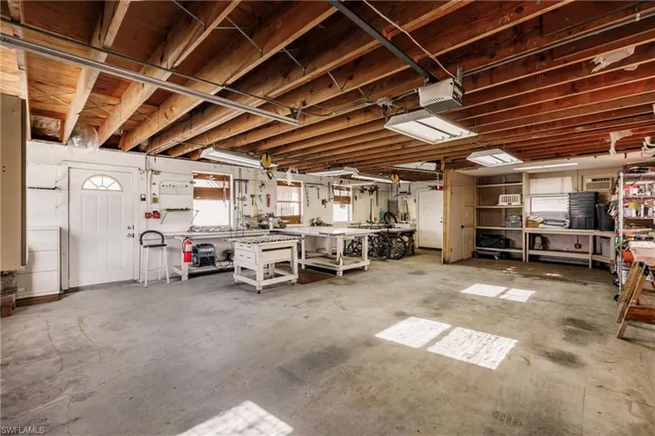 Garage featuring a workshop area and a garage door opener