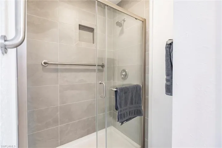 Bathroom featuring a shower with door