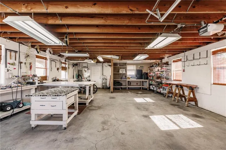 Garage with a workshop area and a garage door opener