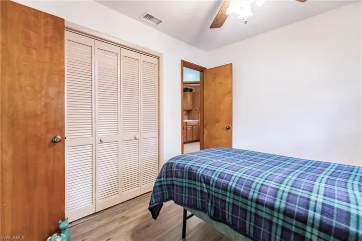 Bedroom with a closet, light wood-type flooring, and ceiling fan