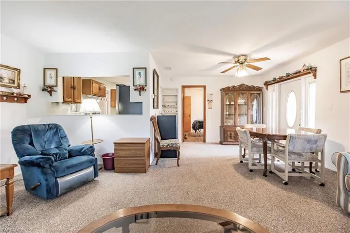 Living room with carpet floors and ceiling fan