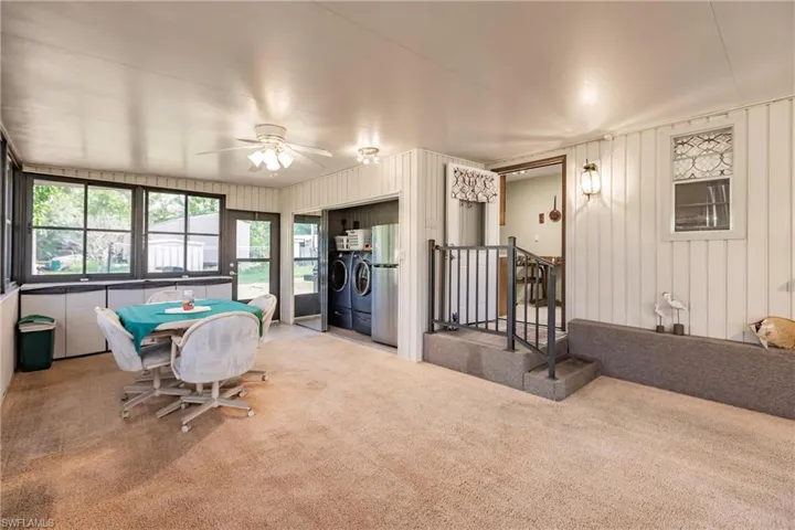Sunroom / solarium featuring ceiling fan and independent washer and dryer