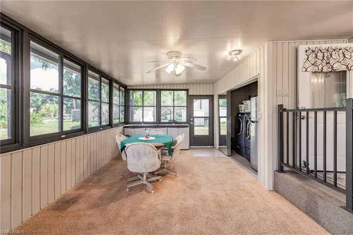 Sunroom / solarium with ceiling fan and washing machine and clothes dryer