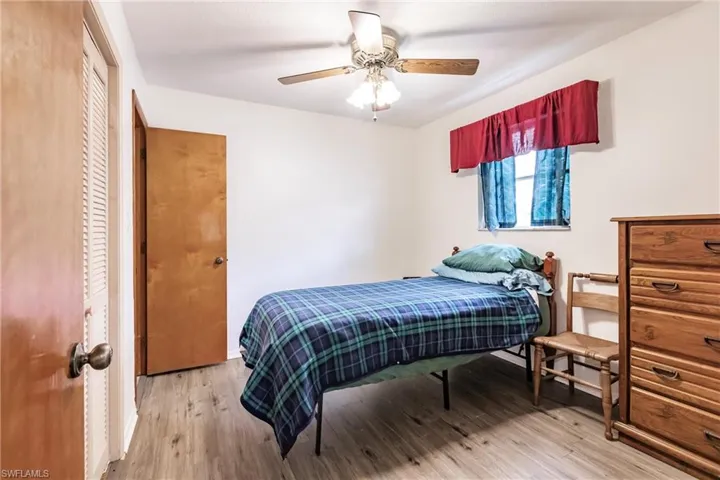 Bedroom with ceiling fan and light wood-type flooring