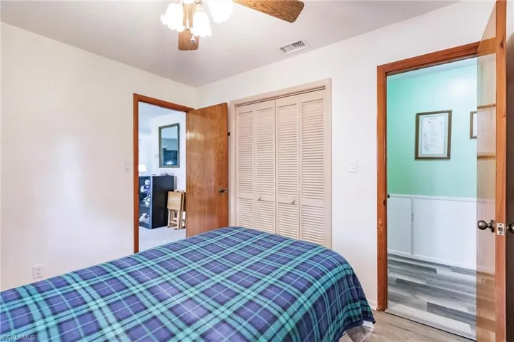 Bedroom featuring a closet, ceiling fan, and light hardwood / wood-style flooring