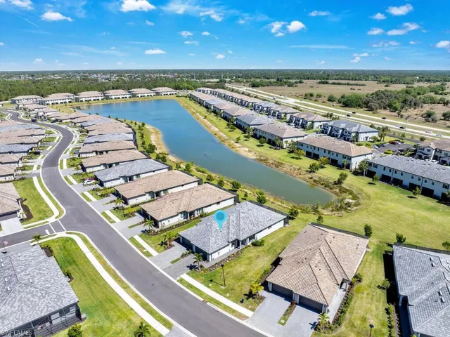 Aerial overview of property's location with a large body of water and nearby suburban area