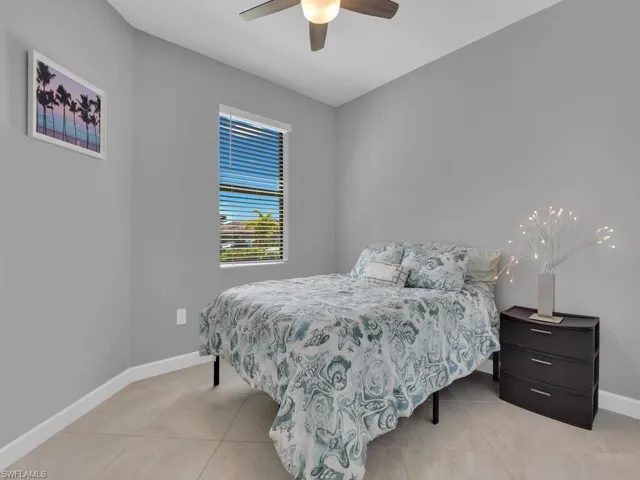 Bedroom featuring ceiling fan and light tile patterned flooring