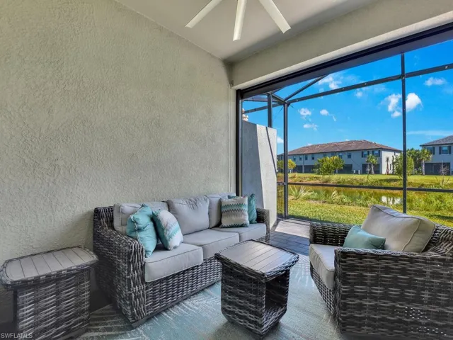 Sunroom / solarium with an outdoor living space, a ceiling fan, and a patio
