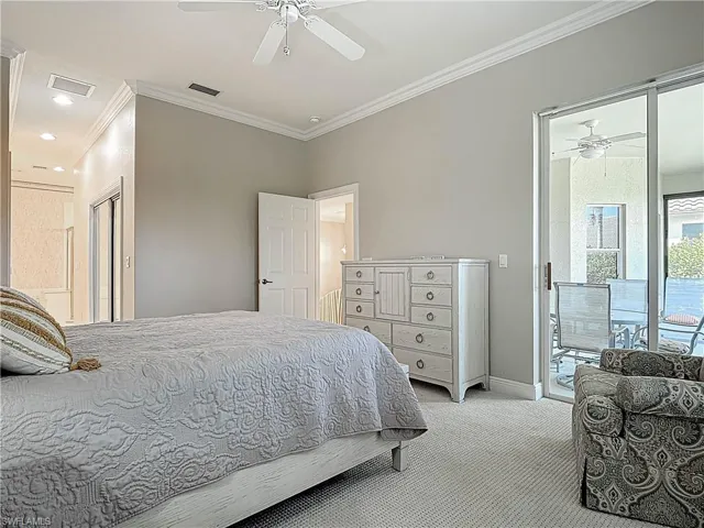 Bedroom with visible vents, access to outside, crown molding, baseboards, and light colored carpet