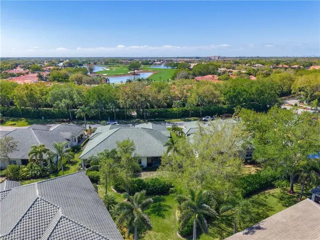 Birds eye view of property with a water view