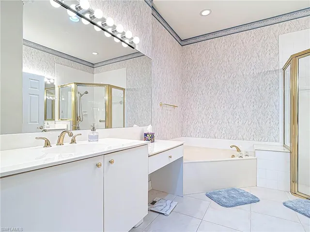 Full bathroom featuring vanity, wallpapered walls, tile patterned flooring, a shower stall, and a bath