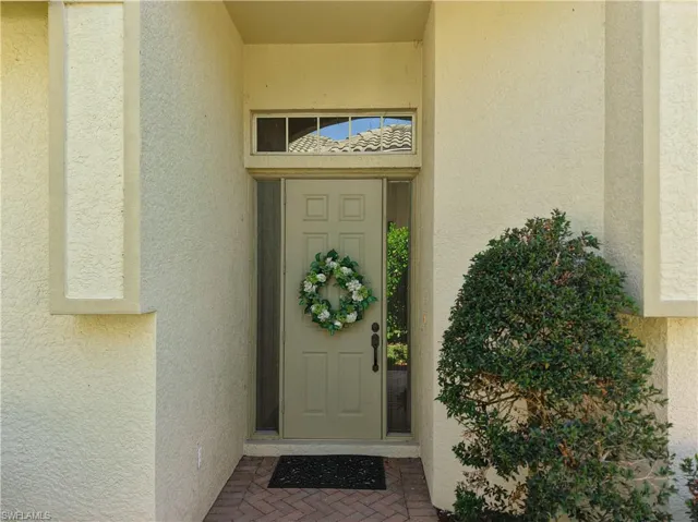 Property entrance featuring stucco siding