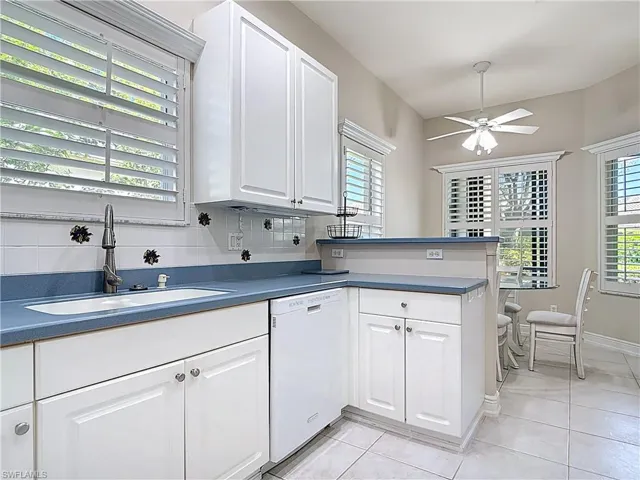 Kitchen with  a healthy amount of sunlight, a peninsula, and ample cabinets and pantry.