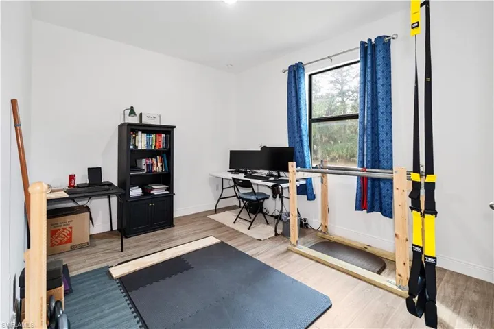 Workout room featuring light wood-style flooring