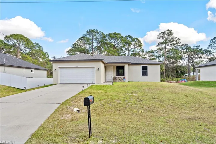 Ranch-style home featuring stucco siding, concrete driveway, and a garage