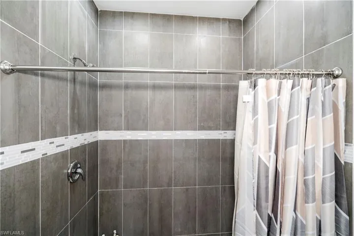 Full bathroom featuring tiled shower