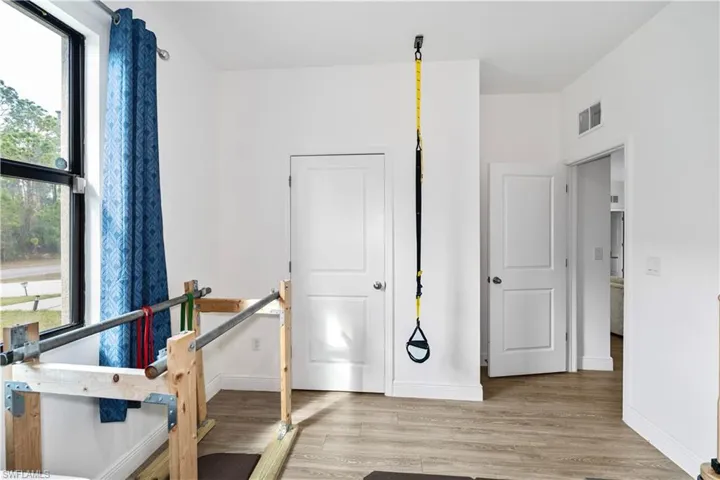 Exercise area with light wood finished floors