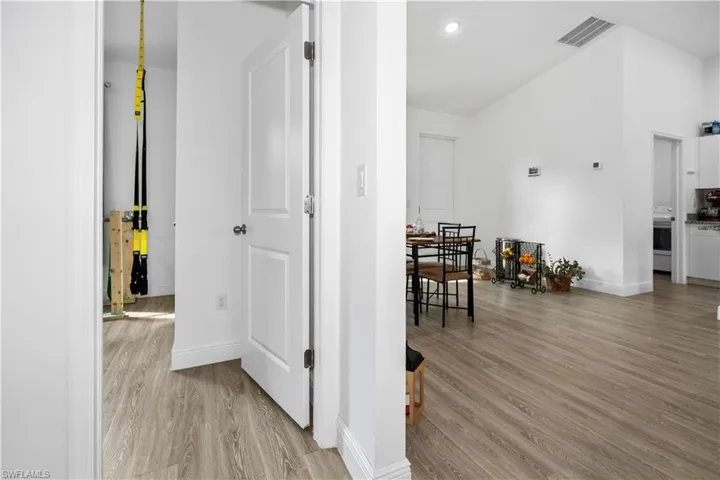 Hallway featuring light wood-style floors, recessed lighting, and washer / dryer