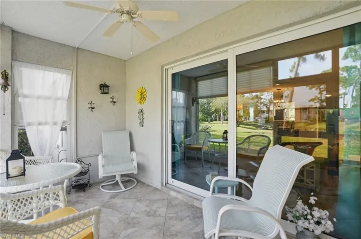 Sunroom with plenty of natural light and ceiling fan
