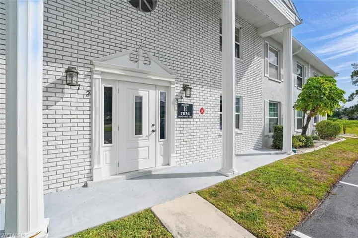 Entrance to property featuring brick siding