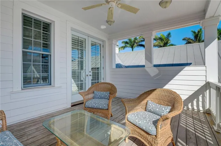 Deck featuring ceiling fan and french doors