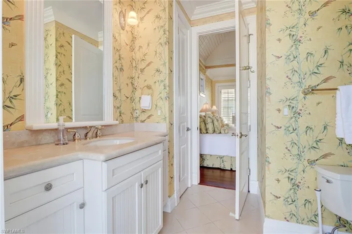 Bathroom with toilet, hardwood / wood-style flooring, vanity, and crown molding