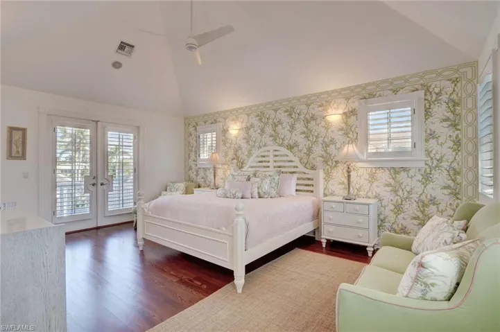 Bedroom with access to outside, ceiling fan, french doors, dark wood-type flooring, and high vaulted ceiling