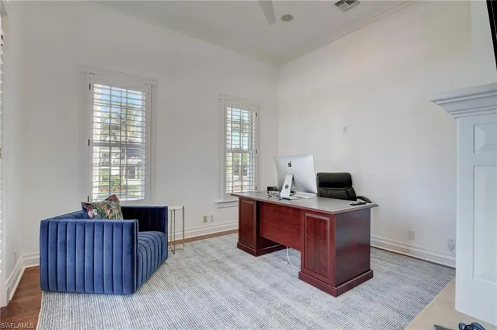 Office space featuring light hardwood / wood-style floors and ornamental molding